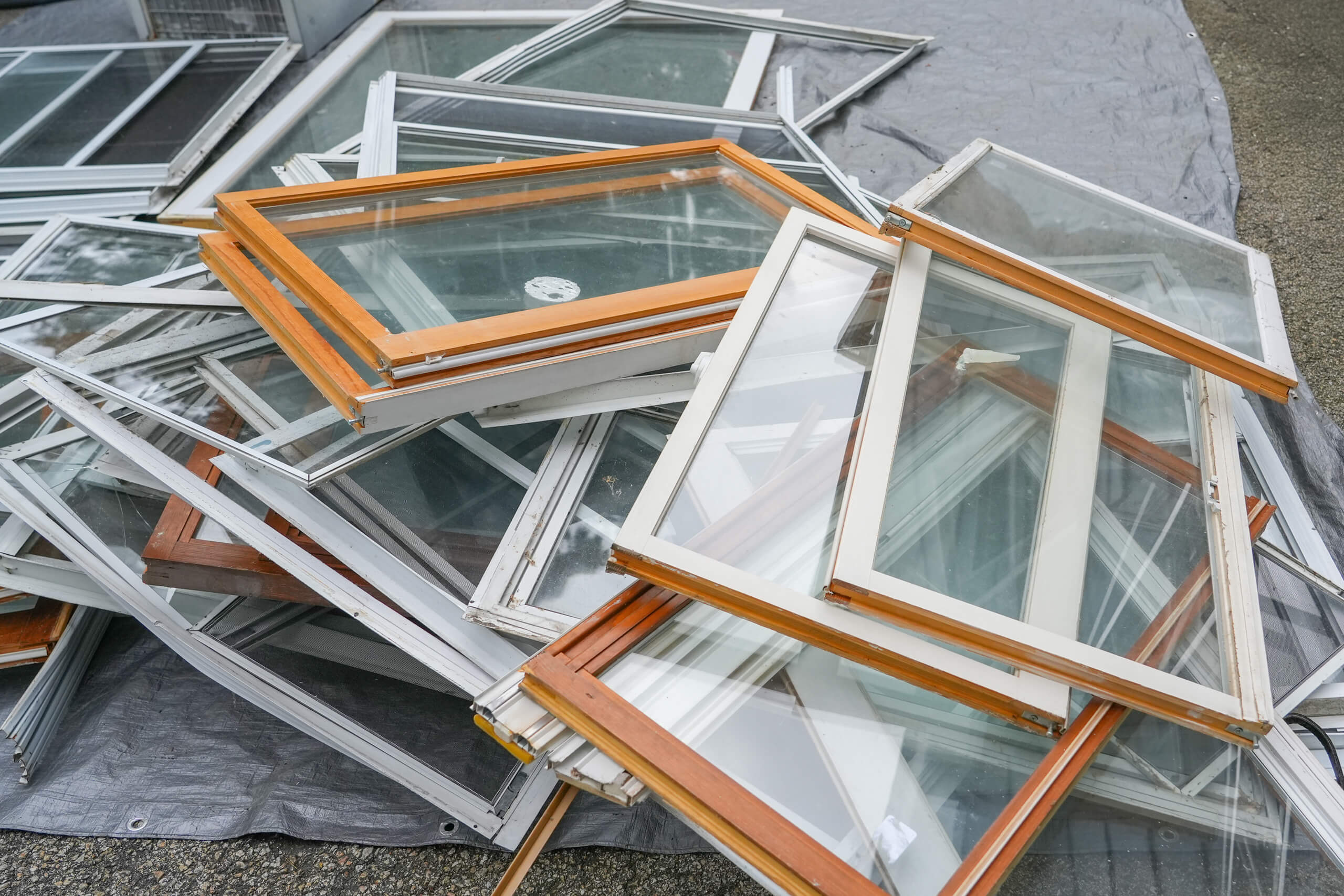 Old windows removed during a whole-home replacement project.