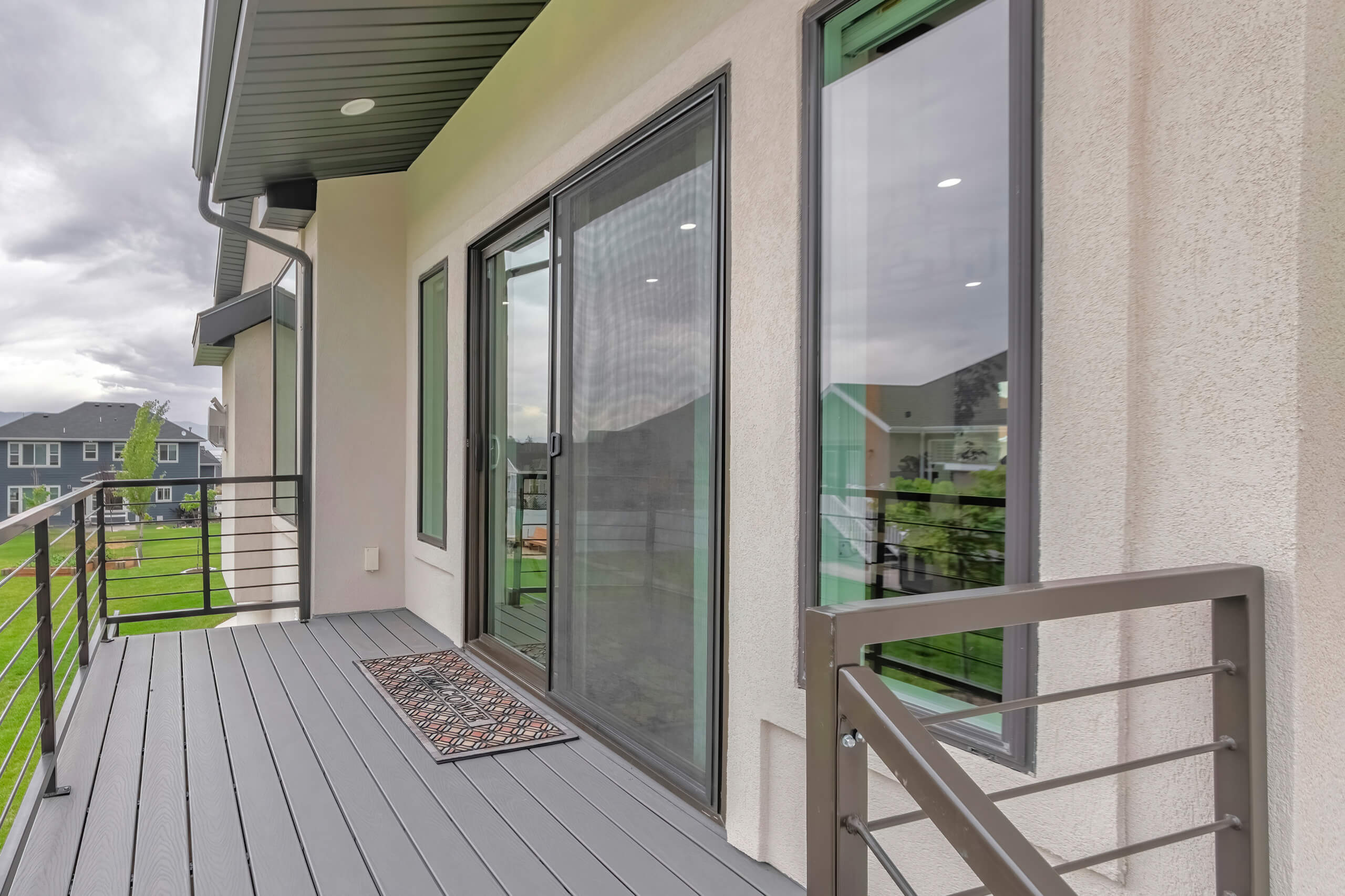 Sliding patio door with screen on modern home balcony, ideal for natural ventilation.